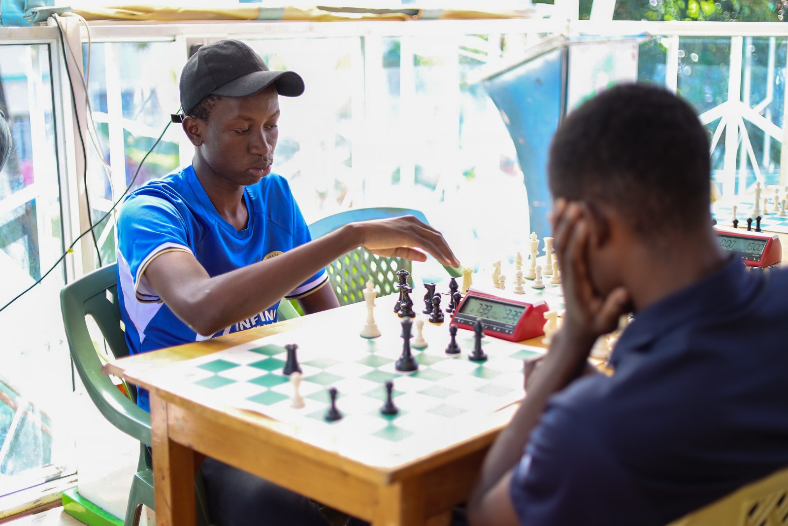 Young players sitting at a chess board during a lesson